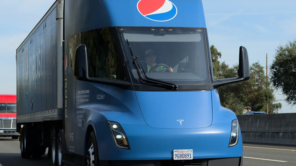 Blue PepsiCo Tesla Semi pulling a trailer on a California freeway